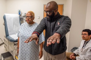 Students working with standardized patient